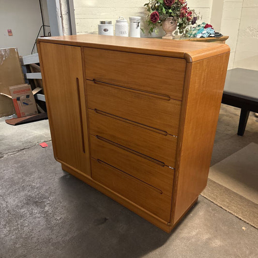 Wooden dresser with four drawers in a room setting