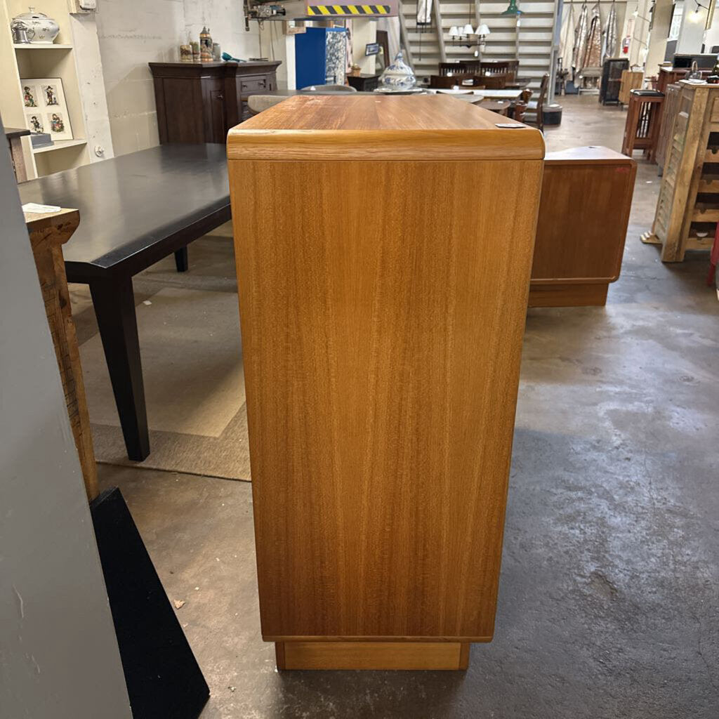 Wooden podium in a warehouse setting with other furniture items.