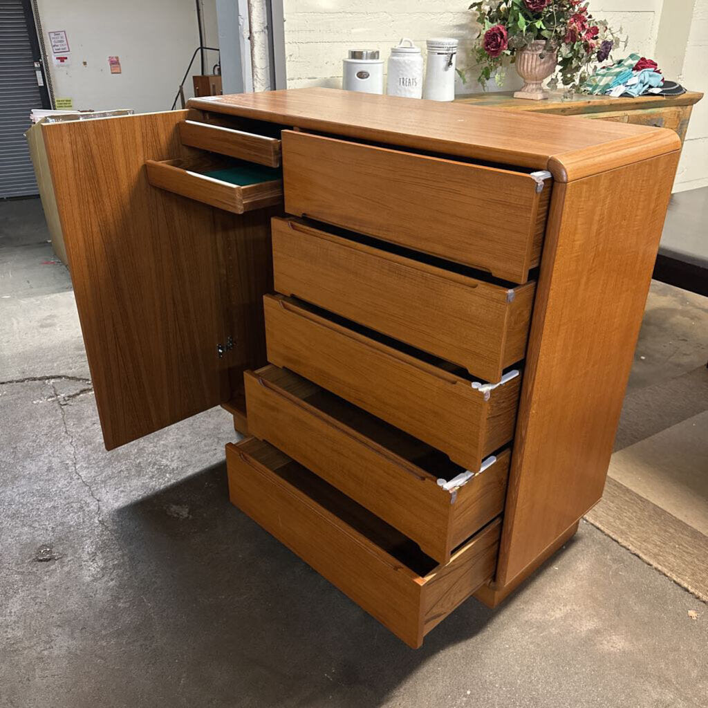 Wooden dresser with open drawer on a concrete floor