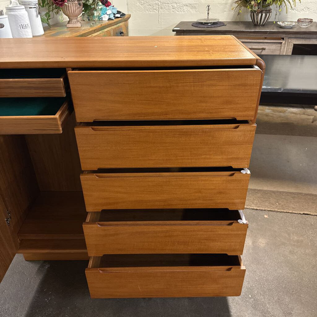 Wooden dresser with multiple drawers in a room setting
