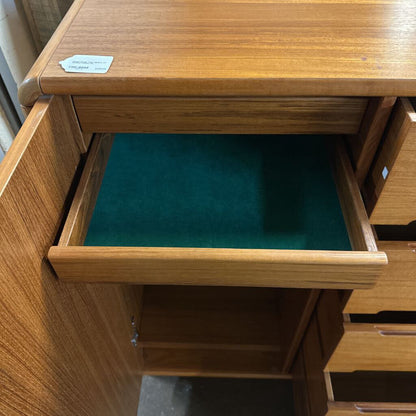 Wooden desk with an open drawer revealing green lining