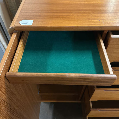 Wooden drawer with green lining and a visible brand label.