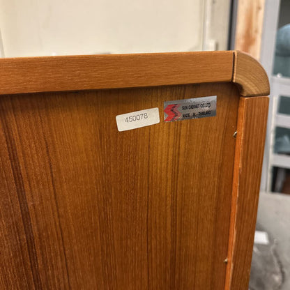 Wooden cabinet with visible label and blurred background