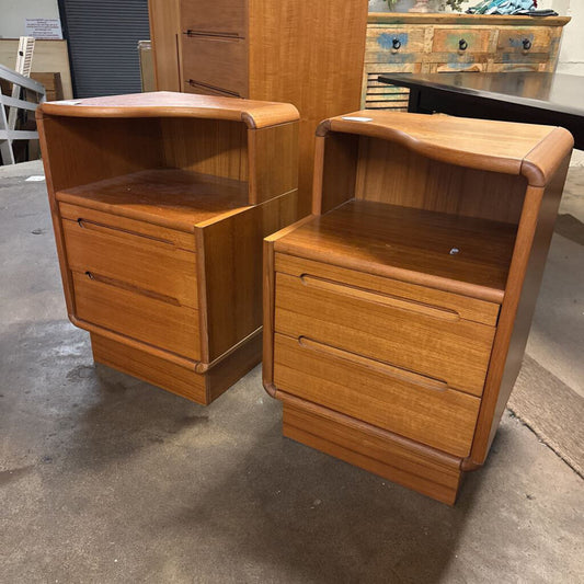 Pair of wooden nightstands with drawers on a concrete floor.