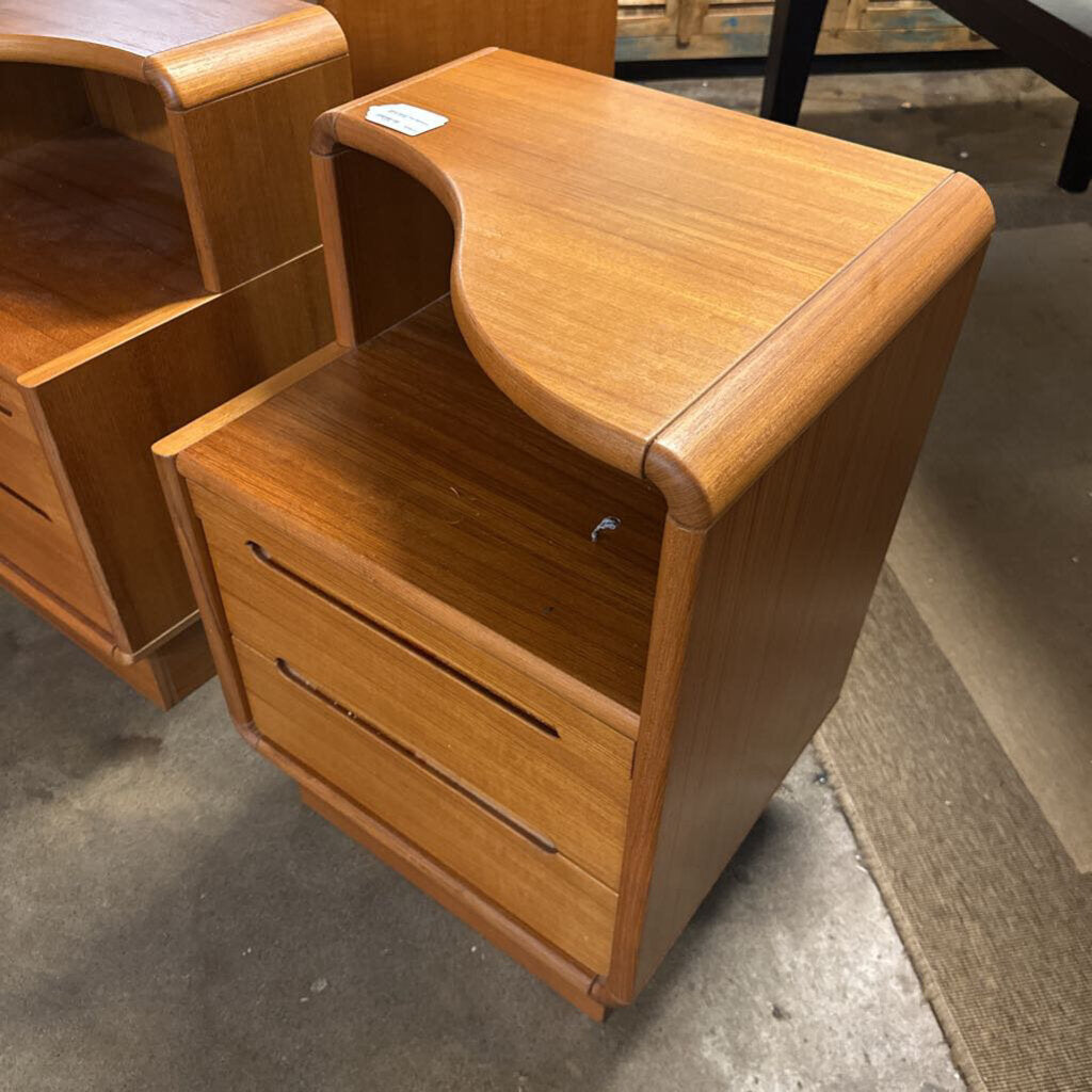Wooden nightstands with curved design on a concrete floor