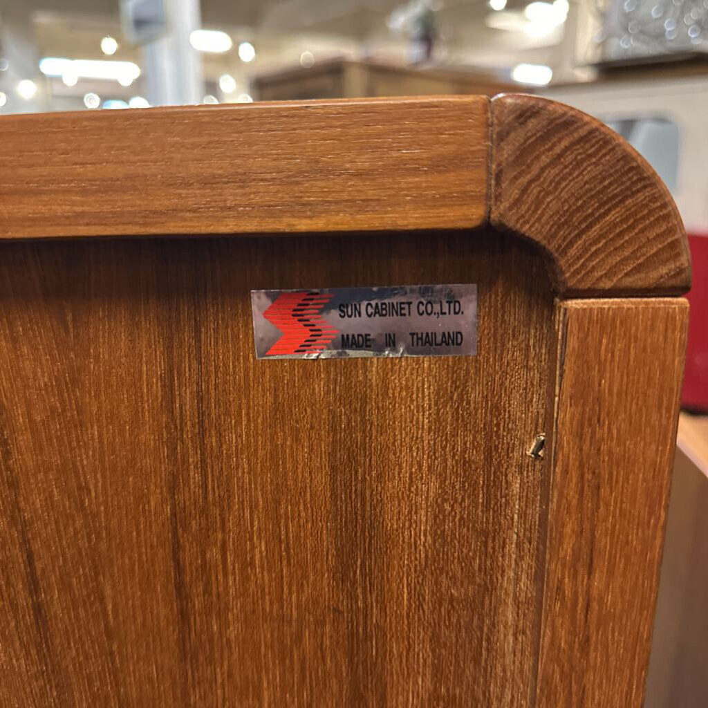 Wooden cabinet with a label on a blurred background