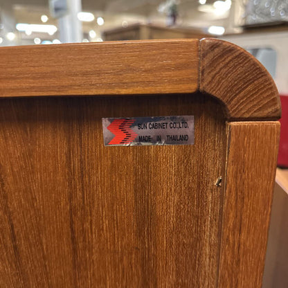 Wooden cabinet with a label on a blurred background