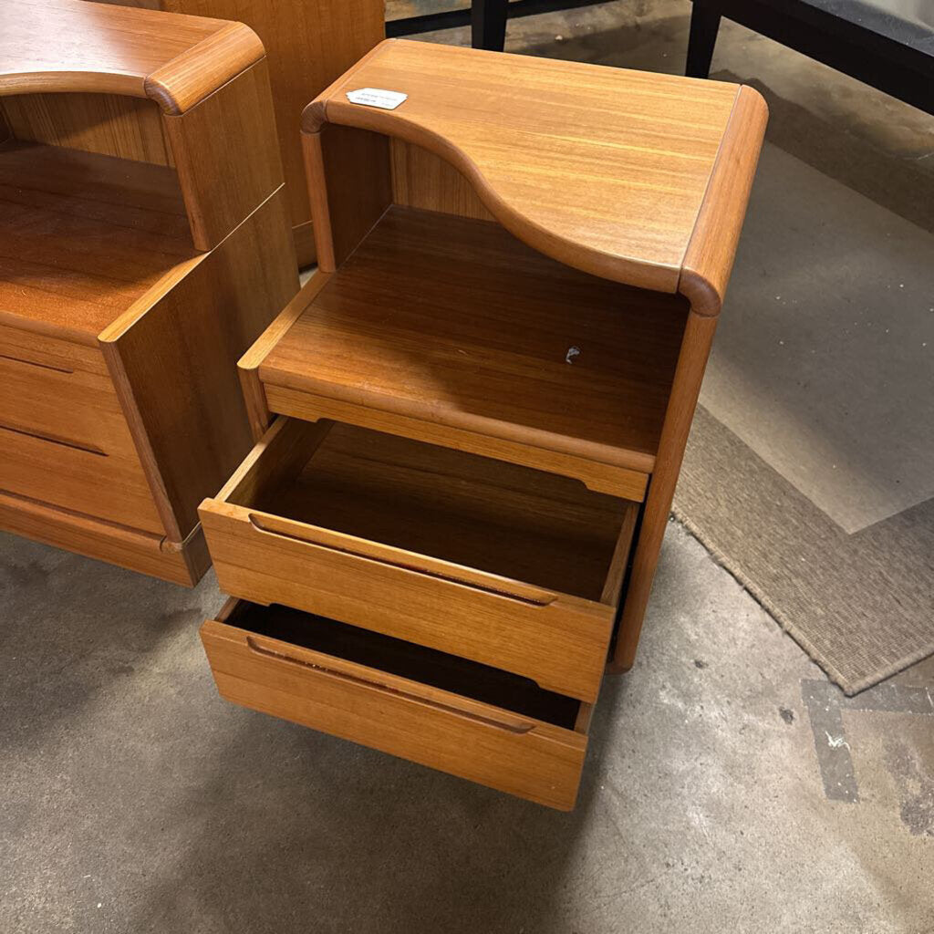 Wooden nightstand with open drawer on a concrete floor