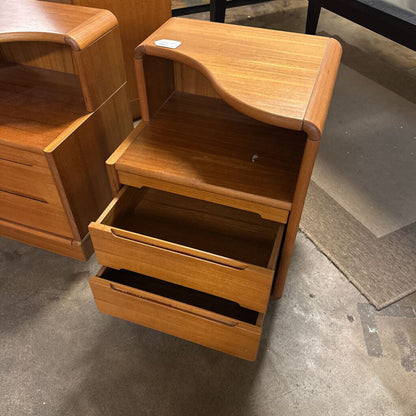 Wooden nightstand with open drawer on a concrete floor