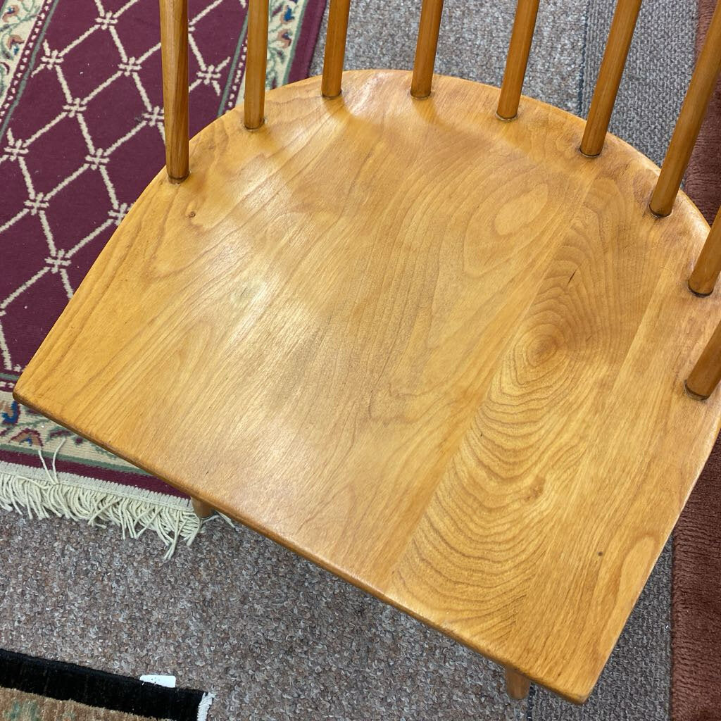 Wooden chair seat on a textured floor