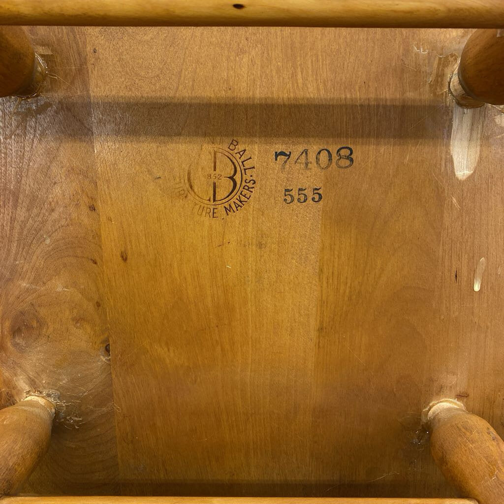 Wooden chair with visible branding and numbers on the backrest