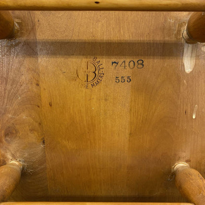 Wooden chair with visible branding and numbers on the backrest