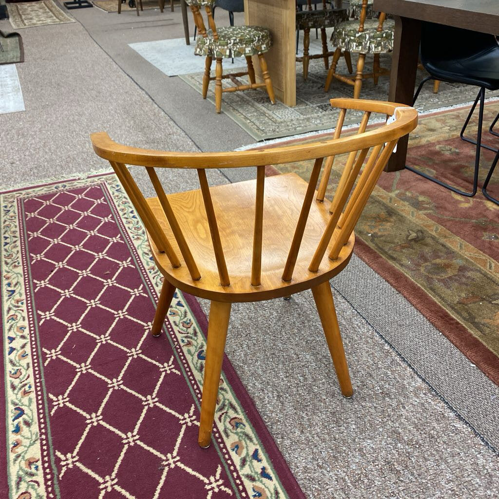 Wooden chair on a patterned rug with a blurred background