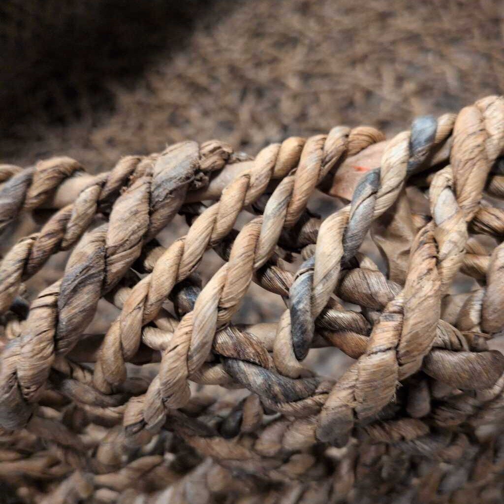 Close-up of a coiled rope on a textured surface