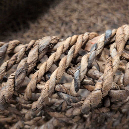 Close-up of a coiled rope on a textured surface