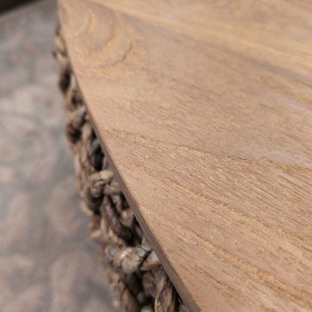 Close-up of a wooden stool with woven base