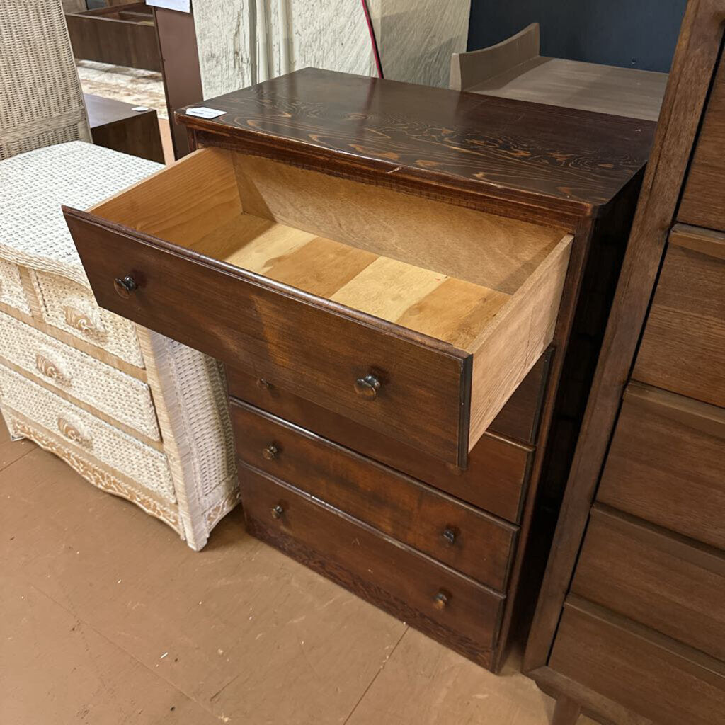 Wooden dresser with an open drawer on a wooden floor