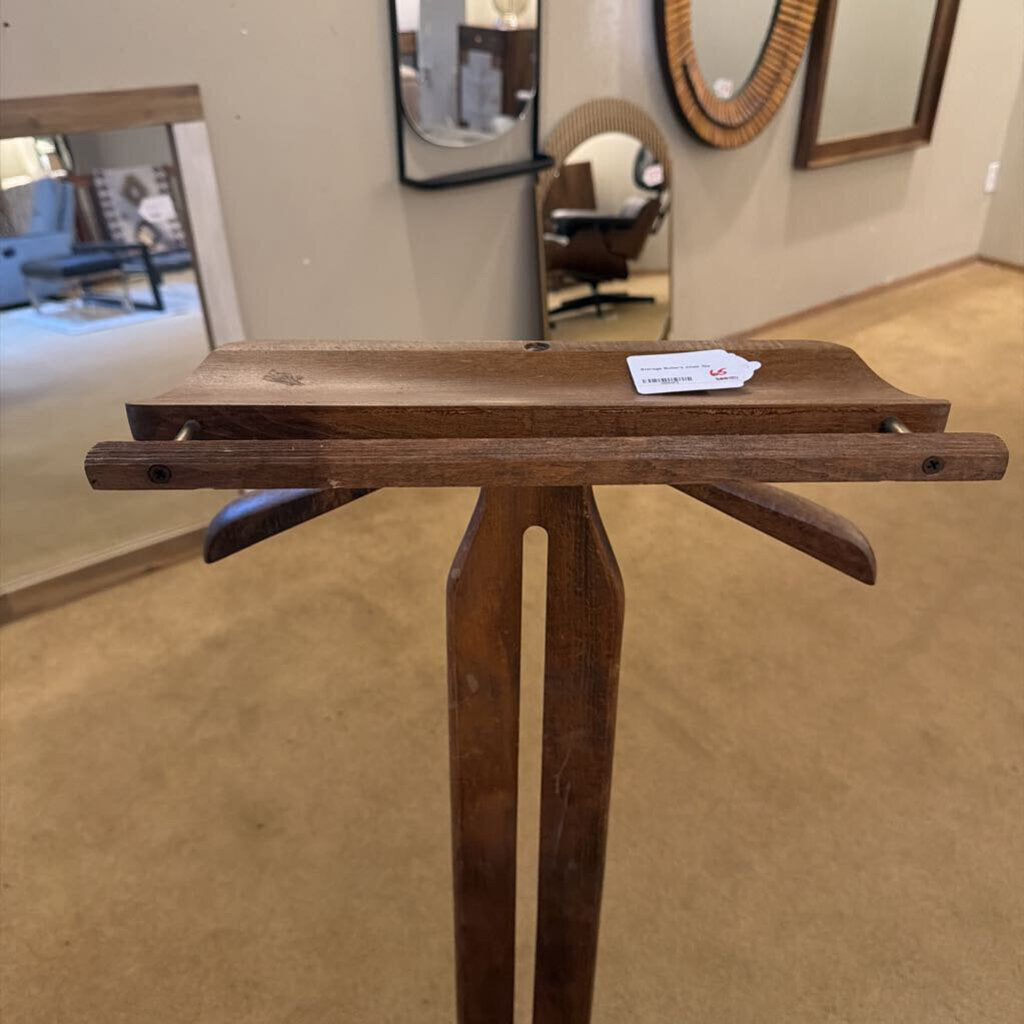 Wooden display stand with a card on a beige floor, possibly in an exhibition setting.