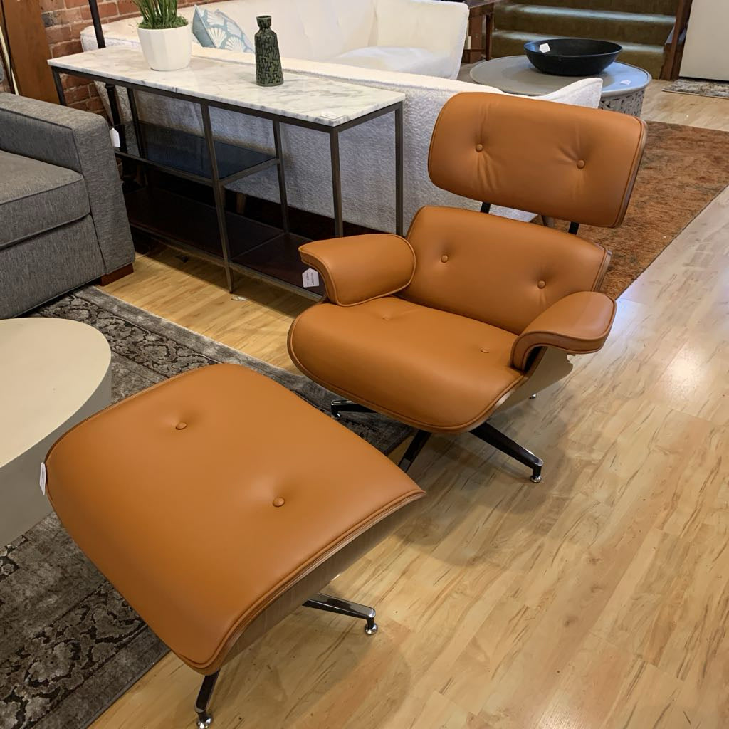 Brown leather chair and ottoman in a living room setting with a couch and coffee table.