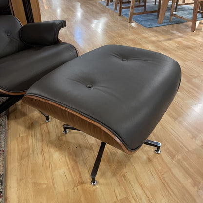 Black leather ottoman on a wooden floor