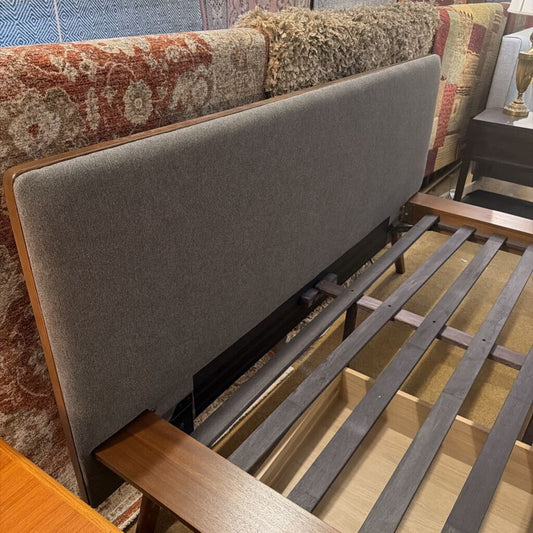 queen bed frame features a warm wood finish, sleek modern lines, and a supportive slatted base.