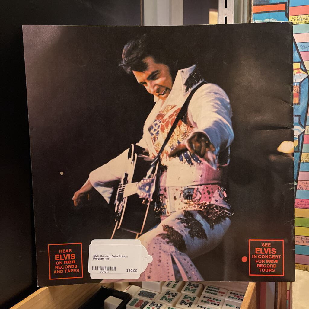 Vinyl record cover featuring an image of a musician in a colorful outfit with text on a shelf.