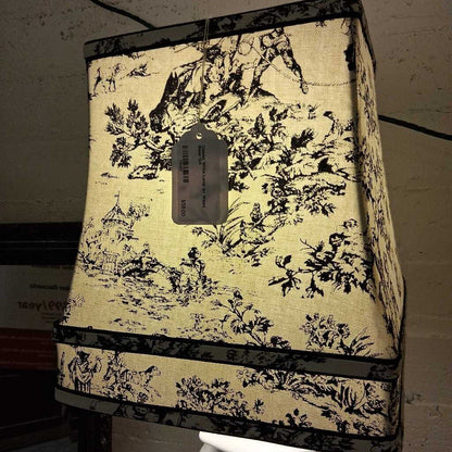 Decorative lampshade with black and white pattern on a plain background