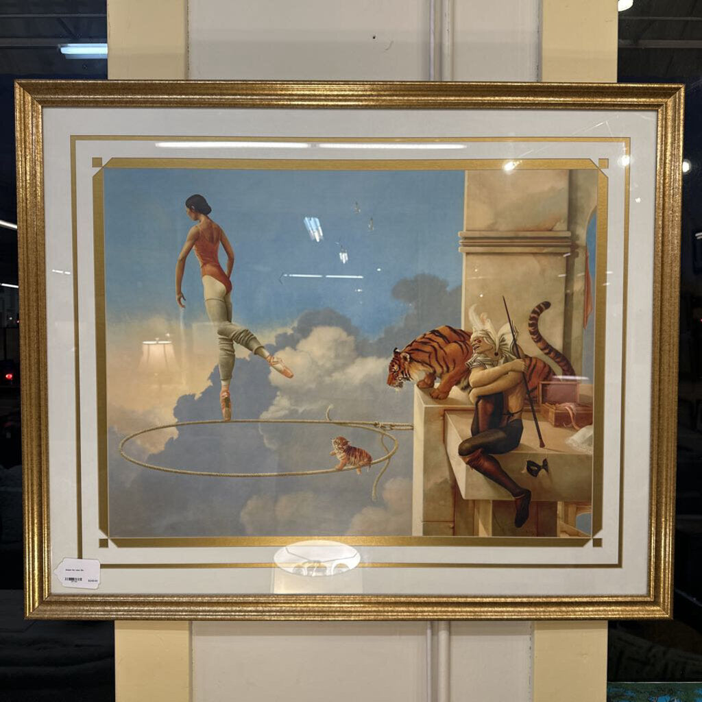 Framed artwork with a scene of a woman, tiger, and other figures against a cloudy sky.