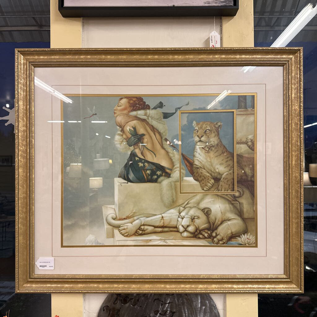 Framed artwork of a woman with a lion and panther in a store setting