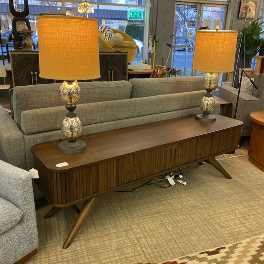 Living room with gray sofa, wooden coffee table, and two lamps.