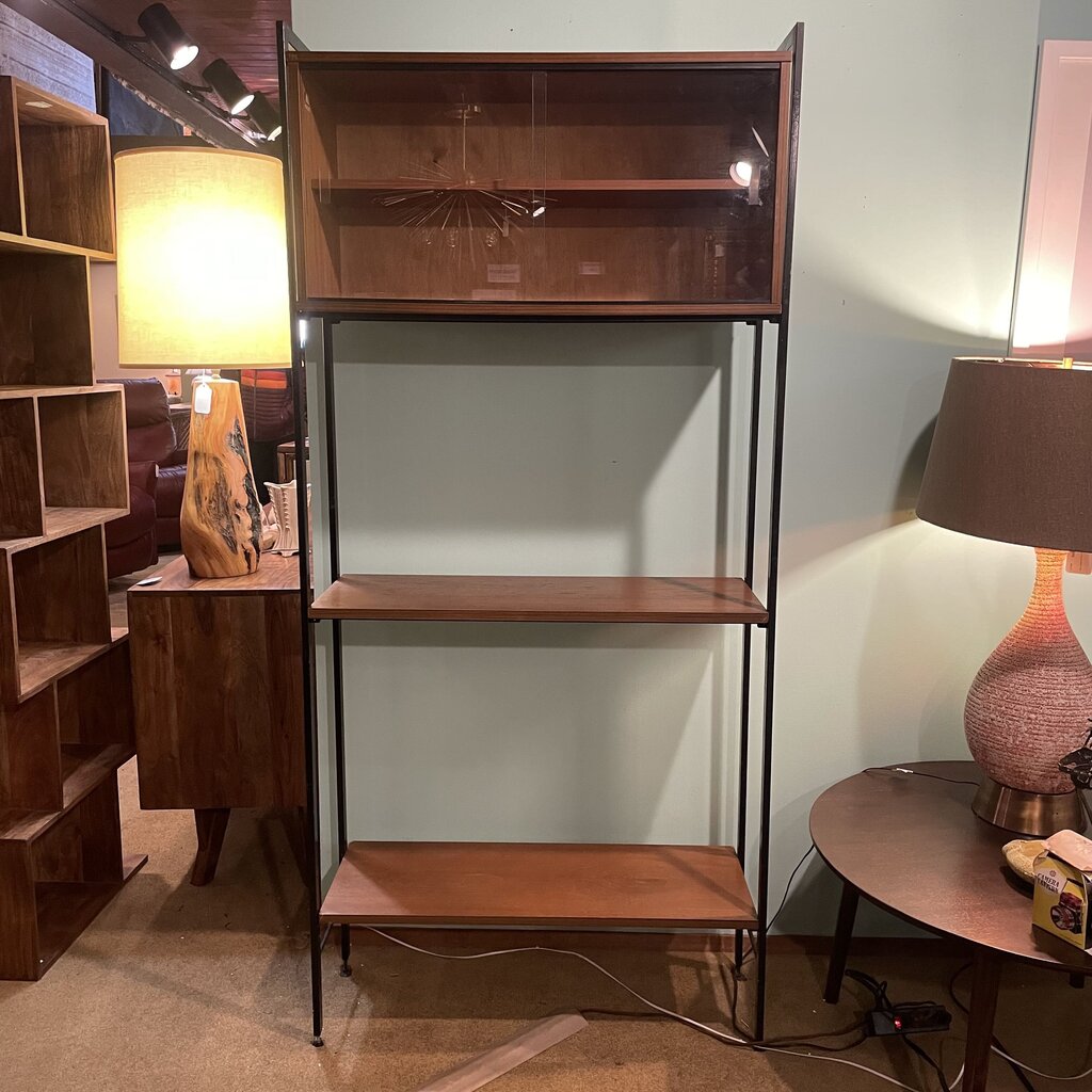 This mid-century modern (MCM) bookshelf features a balanced combination of open display and protected storage. The unit features a minimalist black metal frame that creates a tall, slender silhouette.