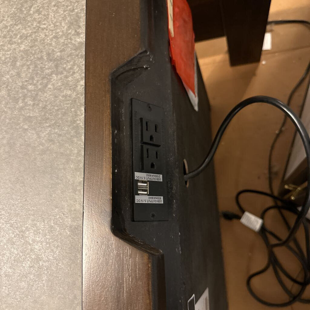 Power strip with multiple outlets on a wooden surface