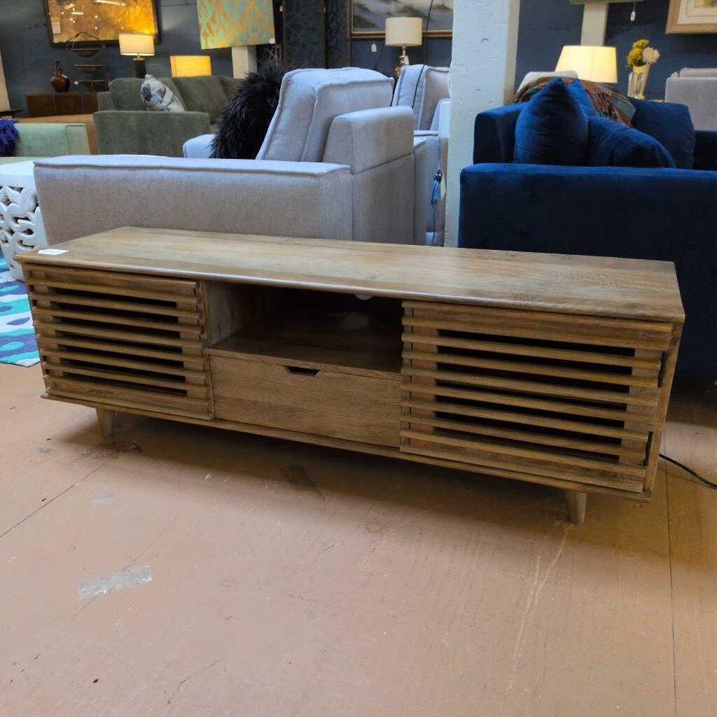 Wooden TV stand in a room with furniture and decor