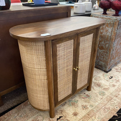 Wooden sideboard with wicker doors in a room setting