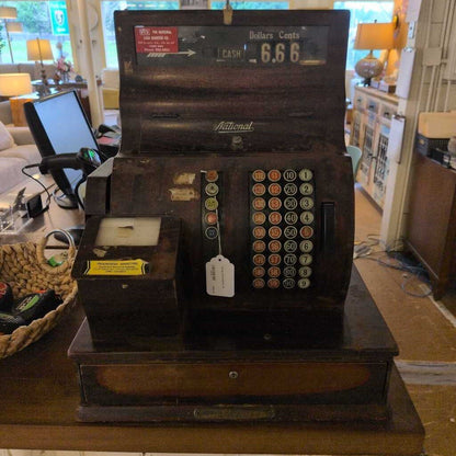 Vintage cash register on a table with a blurred background
