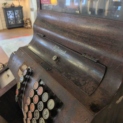 Vintage National cash register with numbered keys in a store setting