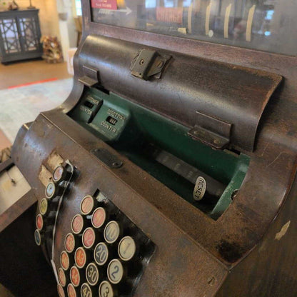 Vintage cash register with colorful buttons in a store setting