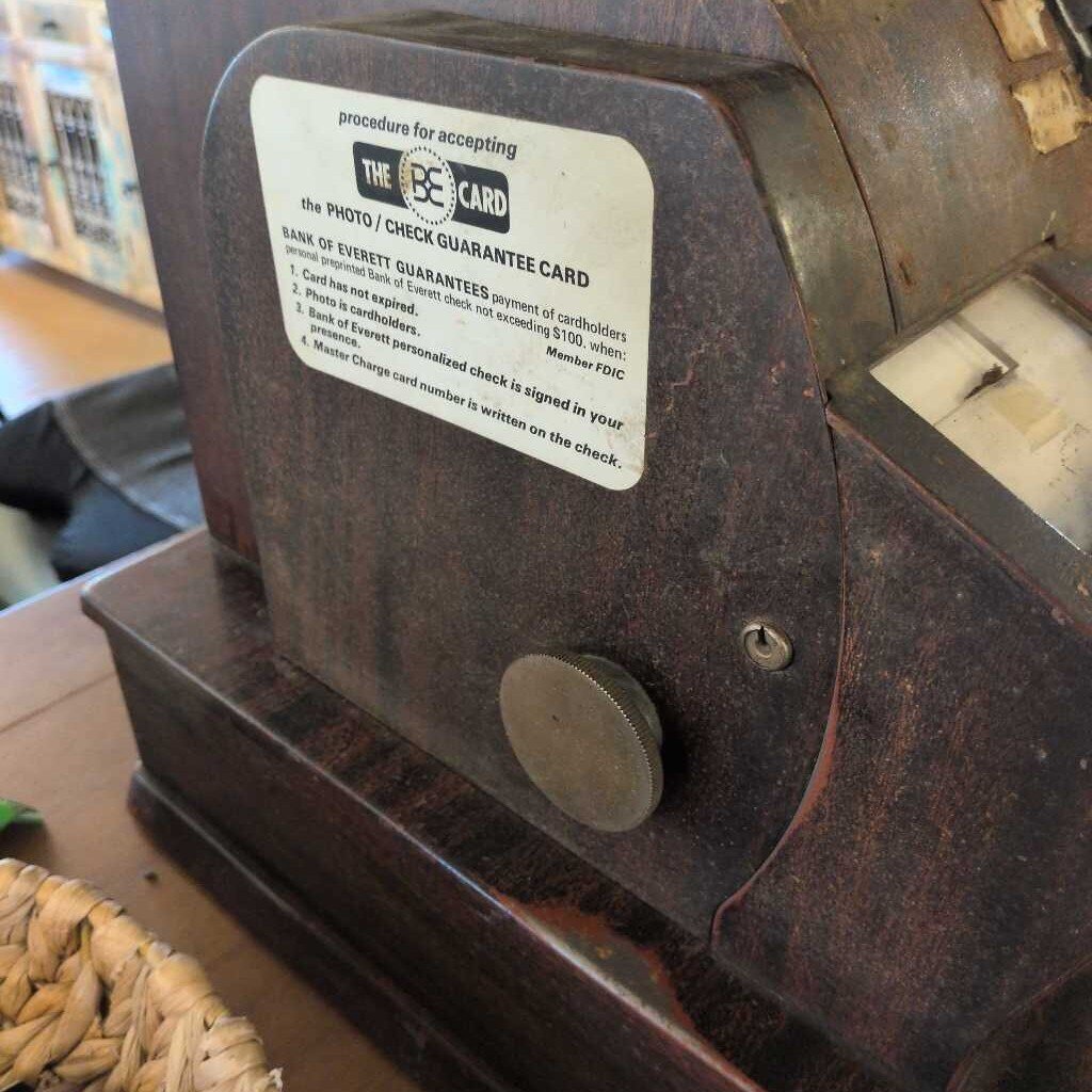 Vintage machine with a label on a wooden surface