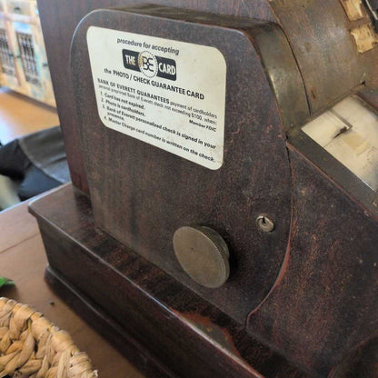 Vintage machine with a label on a wooden surface
