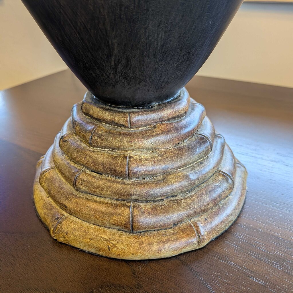 Decorative lamp base with a wooden design on a wooden surface