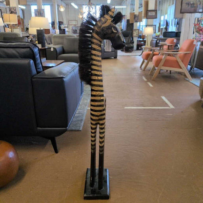 Decorative zebra sculpture in a room with furniture and decor