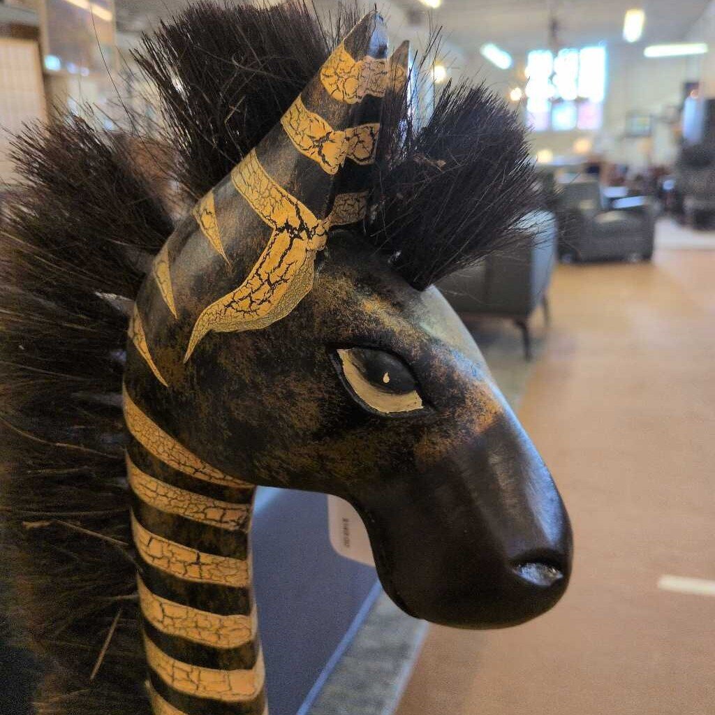 Decorative animal head with striped headdress in a store setting
