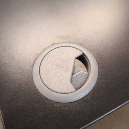 Close-up of a metallic circular object with a textured surface