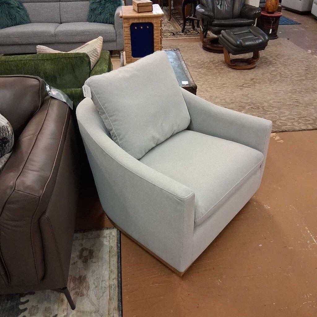 Gray armchair in a room with other furniture