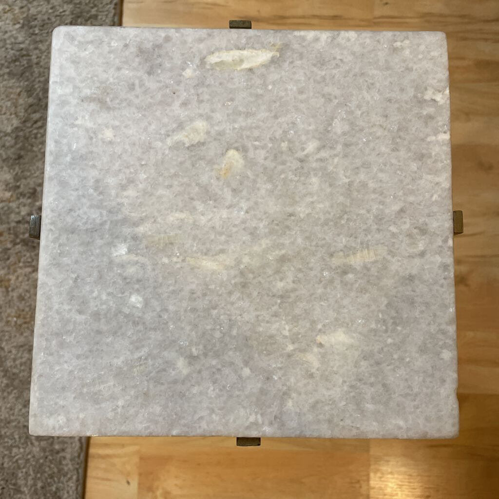 Square marble tile on a wooden floor