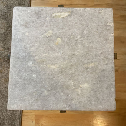 Square marble tile on a wooden floor
