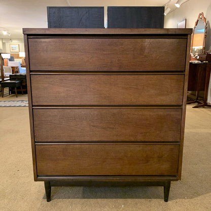 Wooden dresser with three drawers in a room setting