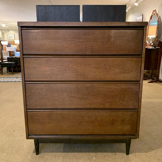 Wooden dresser with three drawers in a room setting