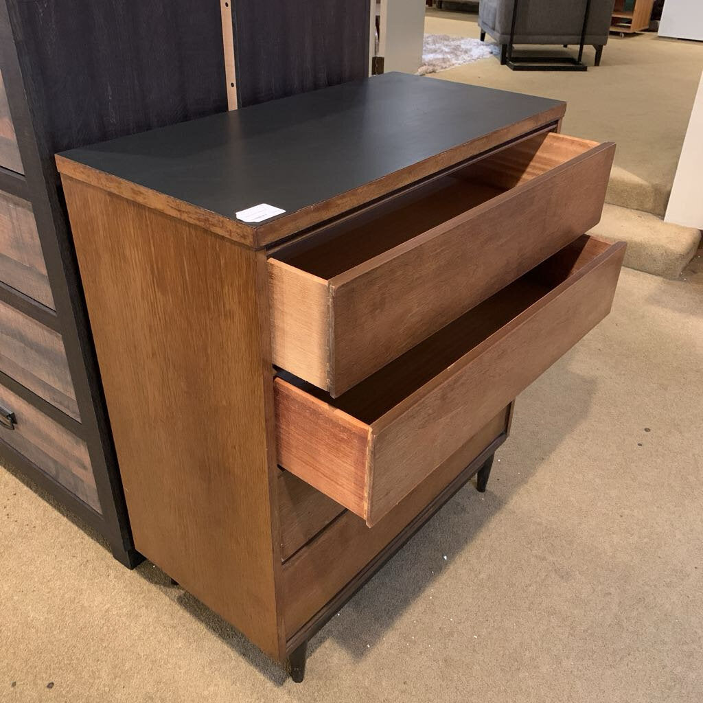 Wooden dresser with open drawers in a store setting