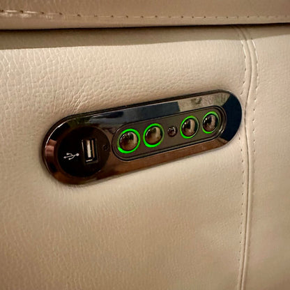 Car interior USB port and control panel with green indicator lights on beige leather.
